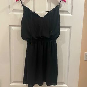 Small black dress by Guess with gold accents and a cinched waist